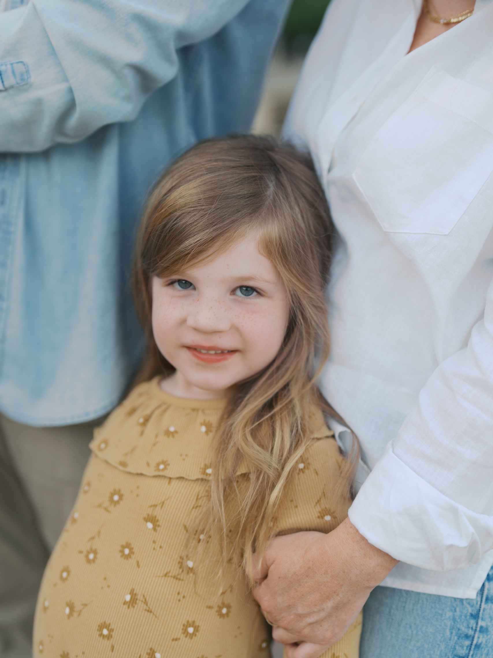 close up of girl smiling standing in front of mom for Colorado Springs Pictures
