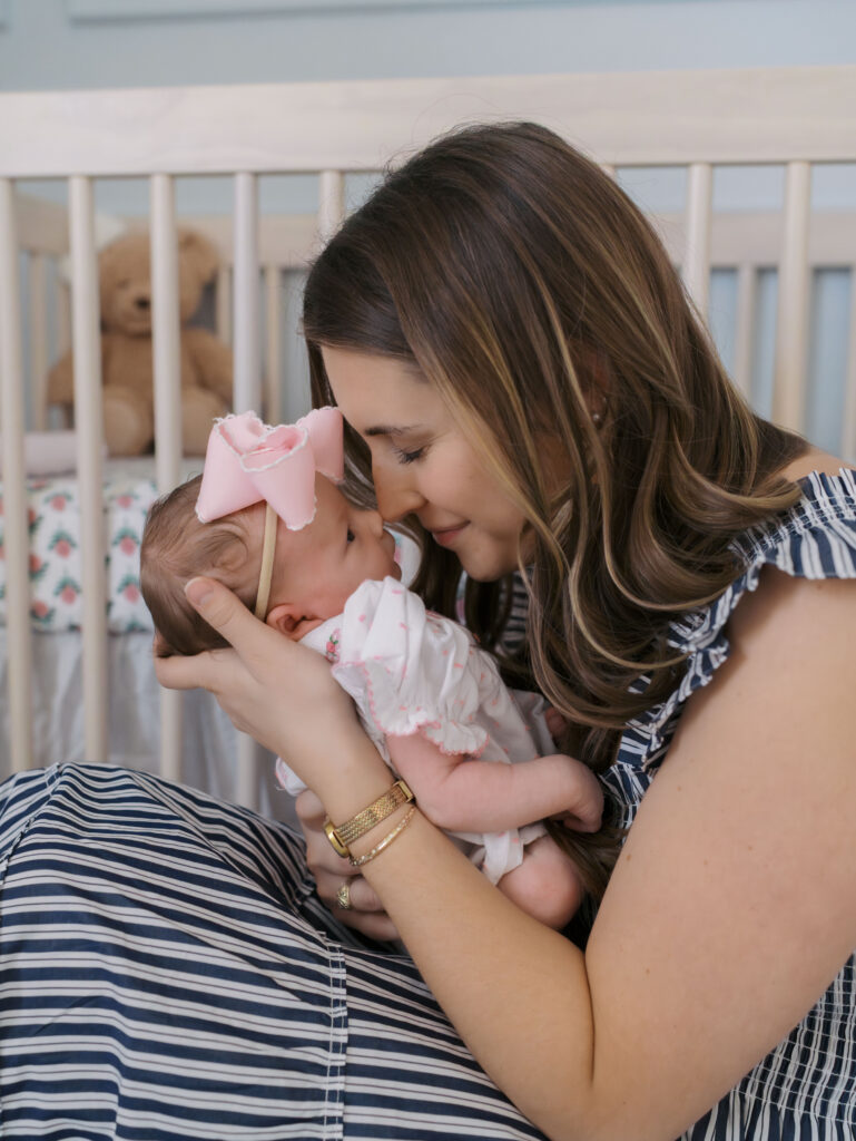 Newborn Photos Colorado Springs showing mom nuzzling newborns nose in arms