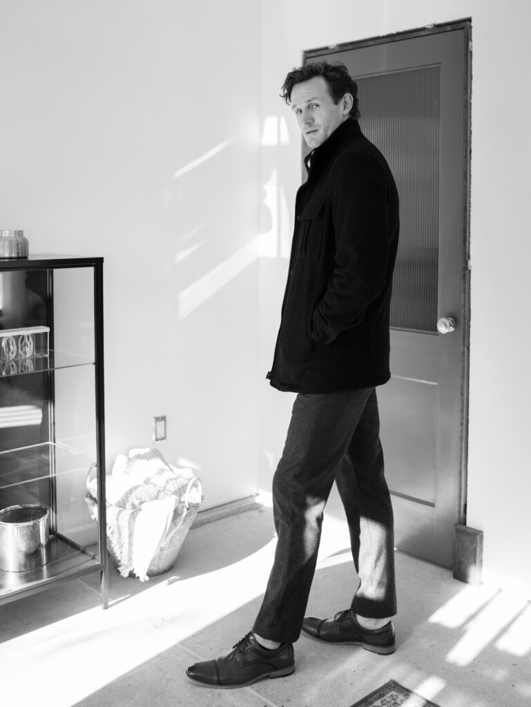 man standing sideways posed for headshots in colorado springs