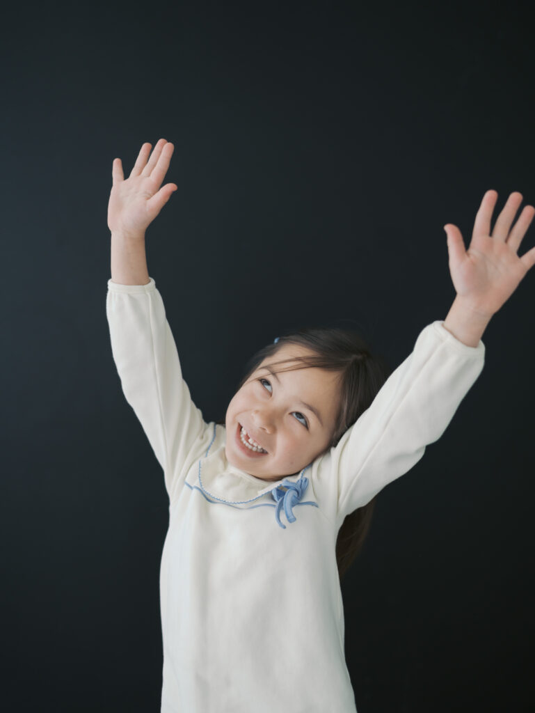 girl with hands in air smiling for Kid Personality Photos Colorado Springs
