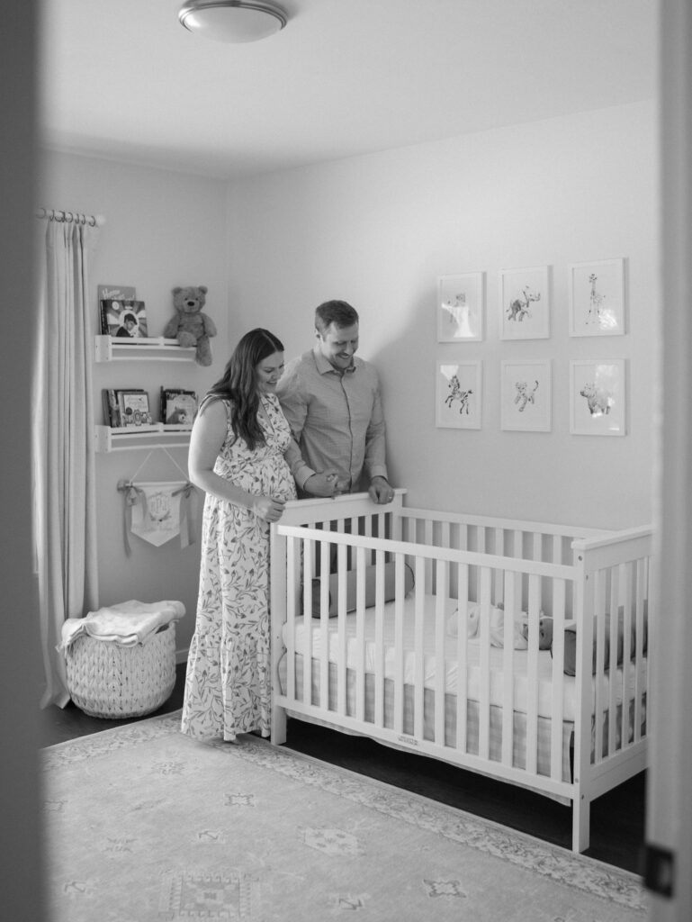 parents standing at end of crib for Colorado Springs newborn photos