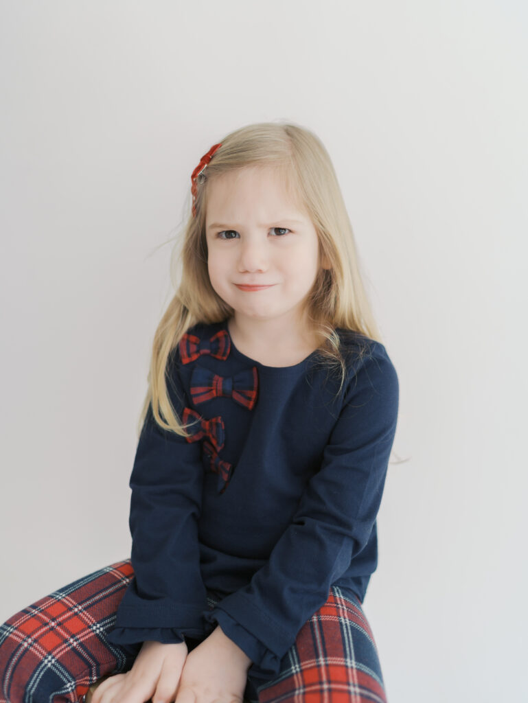 girl making funny face while sitting on stool in colorado springs