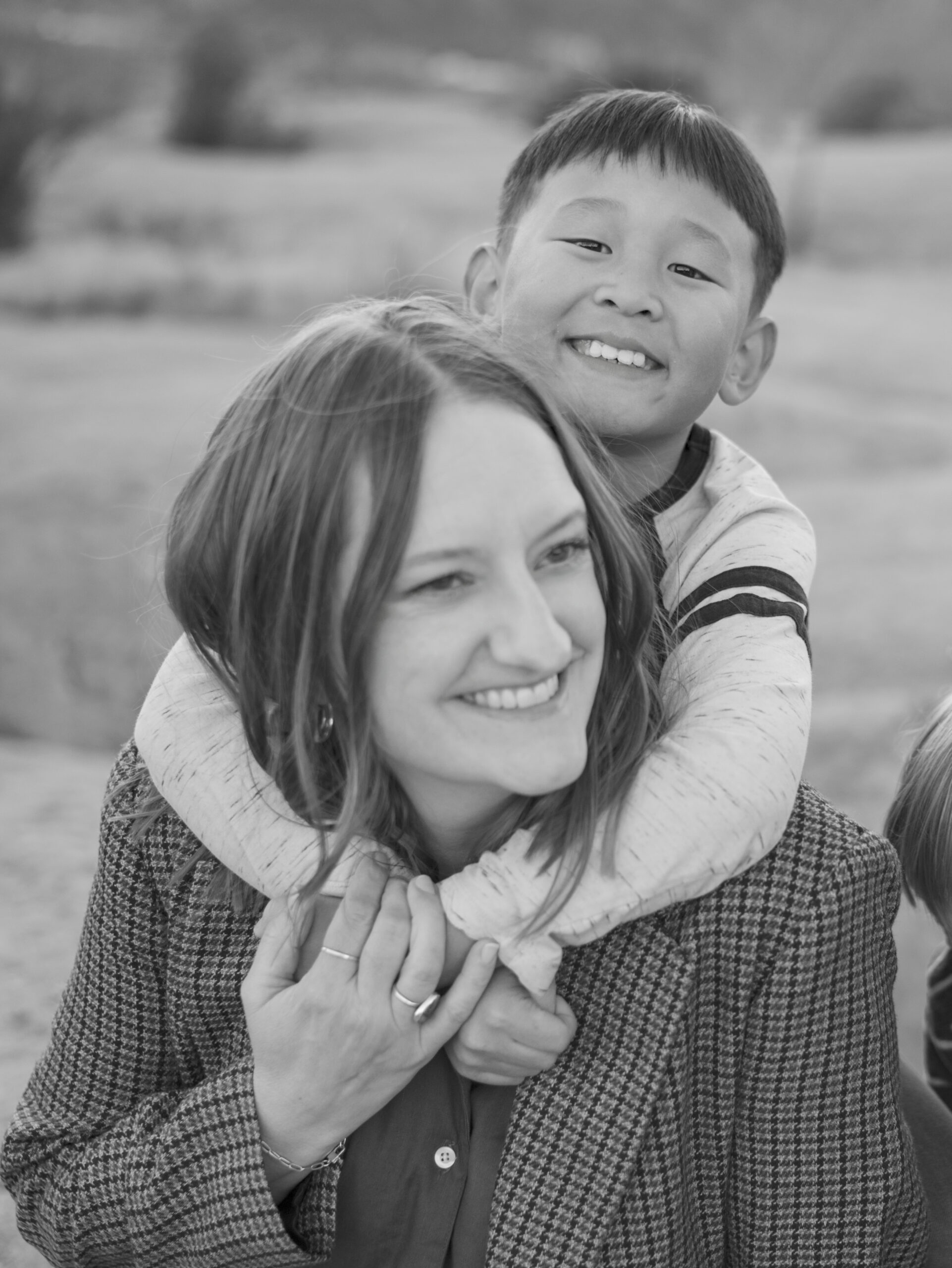 young boy behind mom with arm wrapped around her Family Outings in Colorado Springs