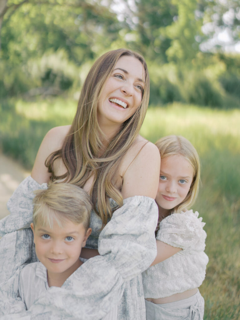 mom with kids surrounding her laughing for Photographer Colorado Springs CO