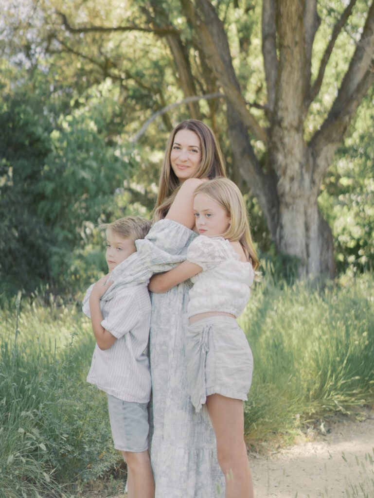 mom with one kids in front and one in back embracing for Photographer Colorado Springs CO