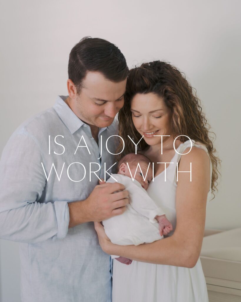 couple close together stand embracing newborn baby