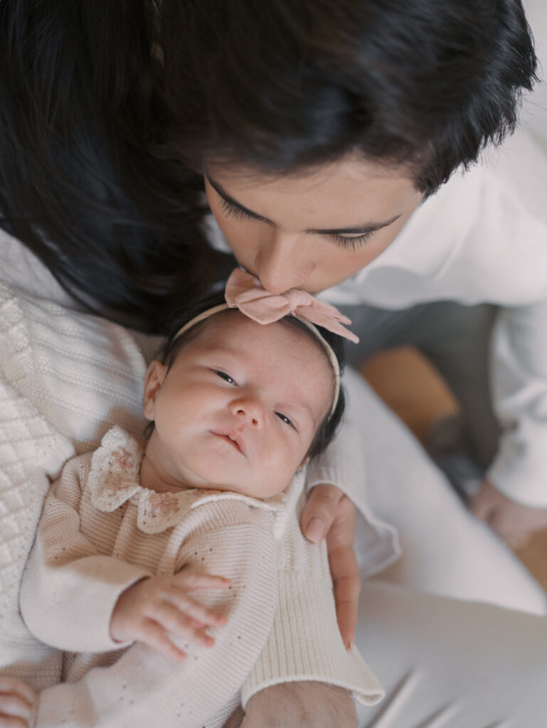 big brother kissing top of newborn sisters head in colorado springs