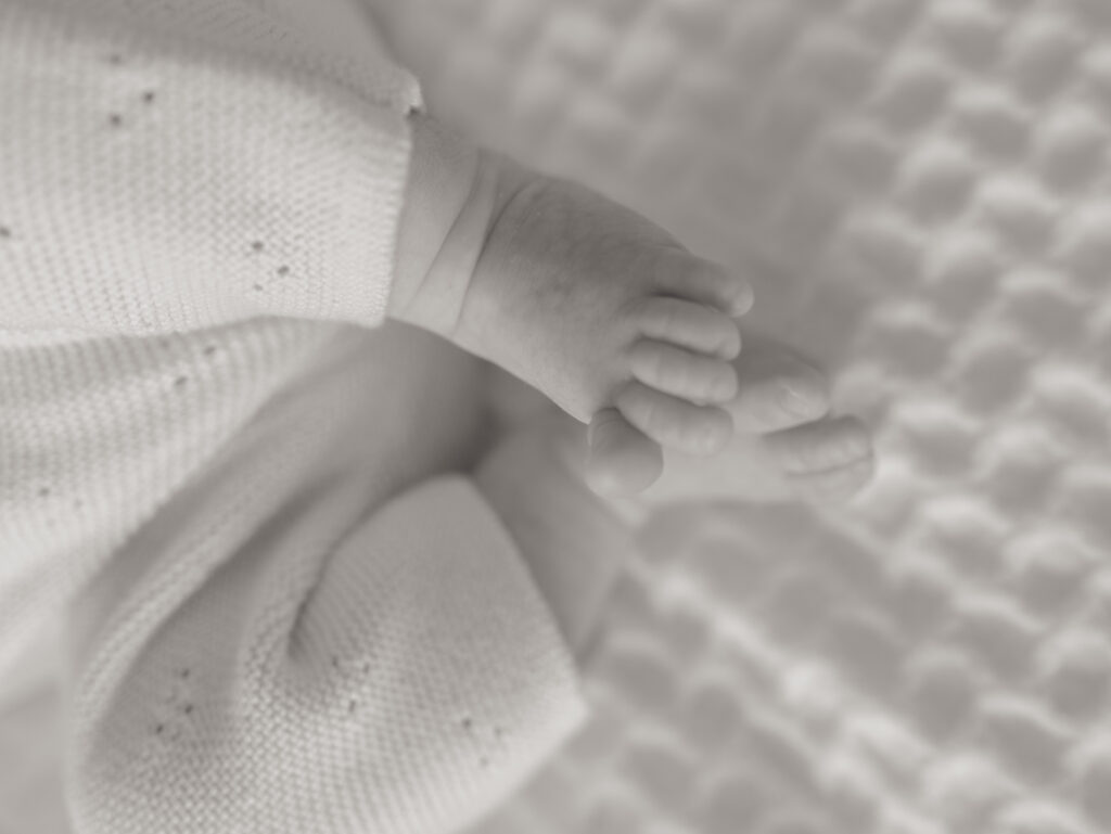 close up of newborn feet in black and white image from colorado springs newborn photo session for when to schedule a newborn session