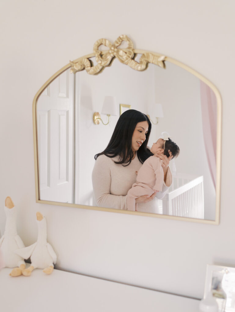 reflection of mom gazing at newborn baby in mirror in colorado springs newborn photos