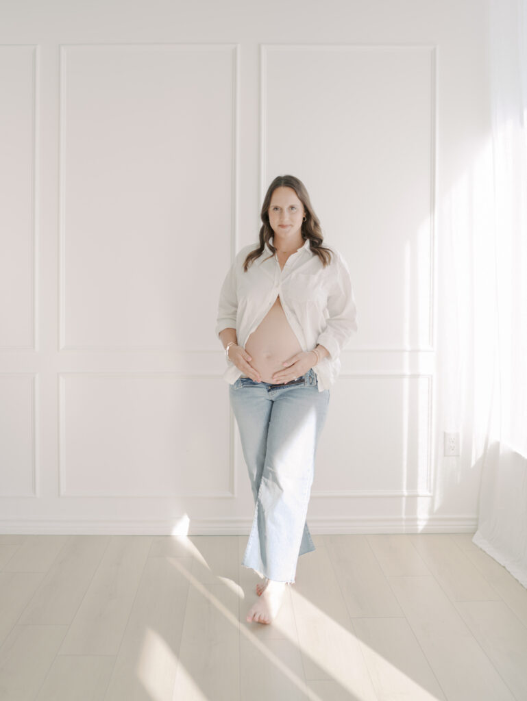 expecting mom smiling in a studio in colorado springs