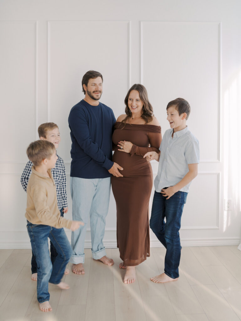 family of five laughing together in studio for Maternity Photos in Colorado Springs