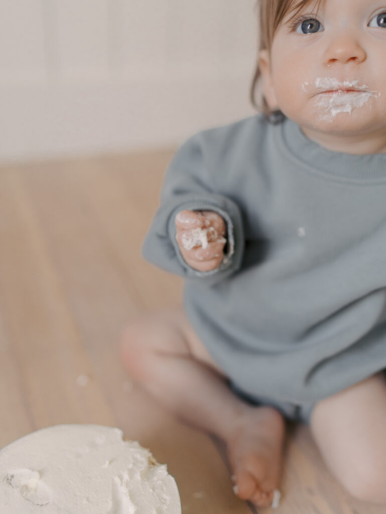 one year next to birthday cake