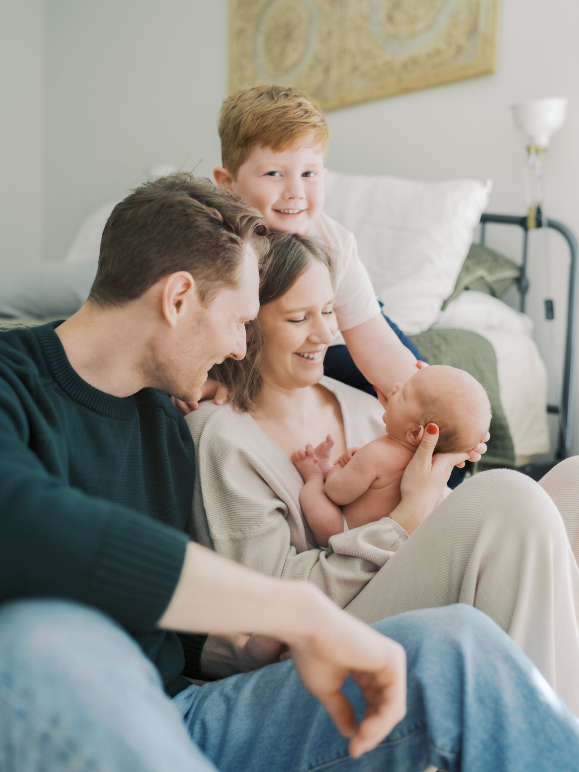 Colorado Springs Newborn photographer captures family of four snuggled close with newborn