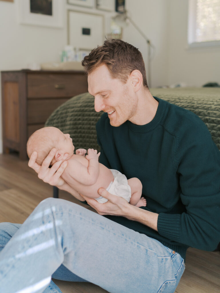 dad with newborn baby in arms for colorado springs newborn photos