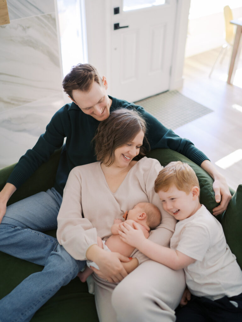 family of four on couch with newborn Colorado Springs Newborn Photography