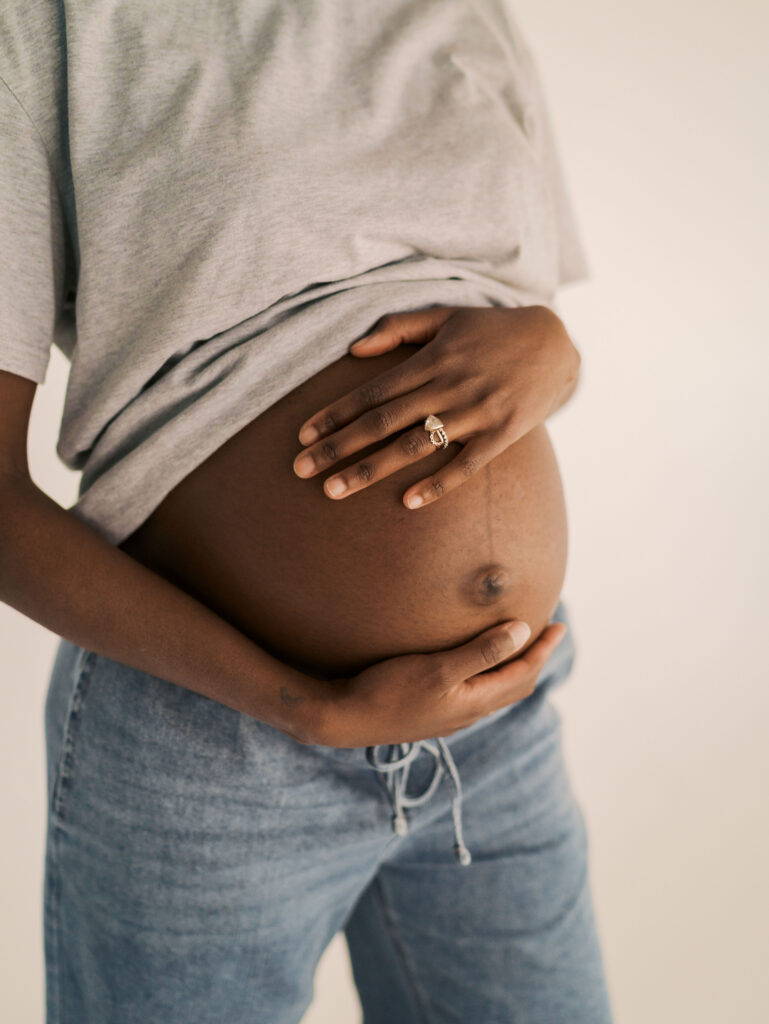 moms hands on belly for maternity photos for colorado maternity photography guide with Lauren Bounds Photography