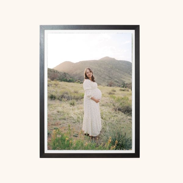 custom framed photos of an expecting mom with mountains behind her by Lauren Bounds Photography